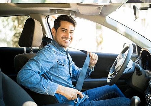 Man buckling in to his car for his next rideshare