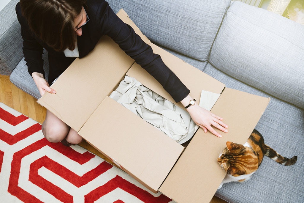 Business woman unpacking unboxing cardboard box from Target
