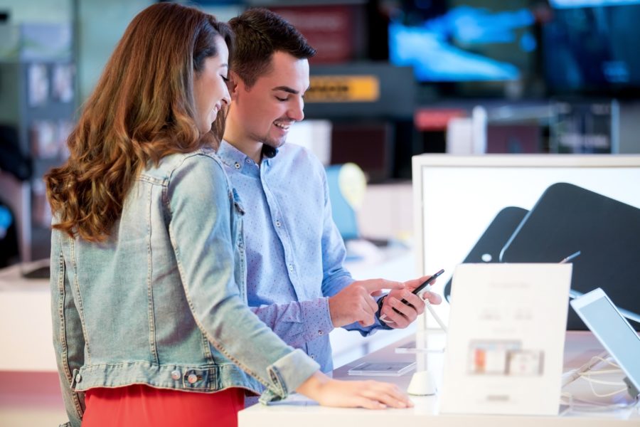 image of Couple shopping for latest laptop and smartphone