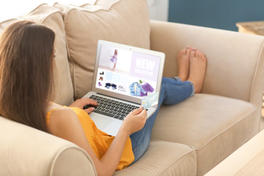 image of Young woman shopping online with credit card